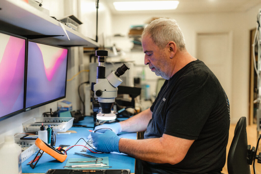 Certified technician repairing phones and computers for Seattle and Bellevue customers