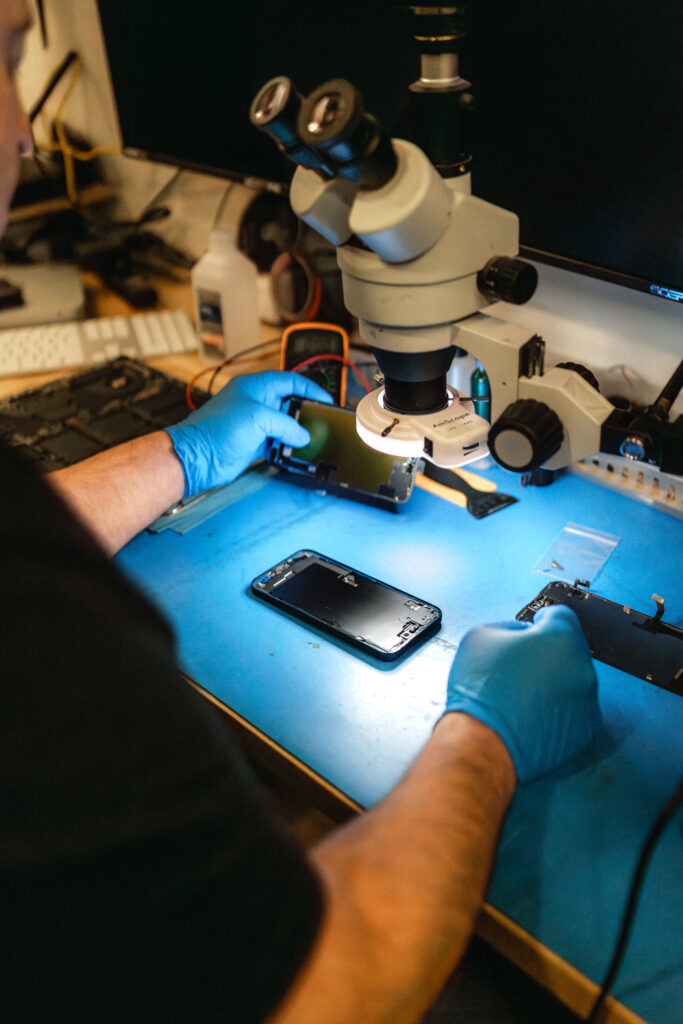 certified android techncian working on an android device for screen repair cleaning and battery replacement