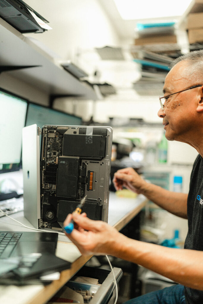 certified apple mac technician repairing a macbook pro for liquid damage screen logic board and battery