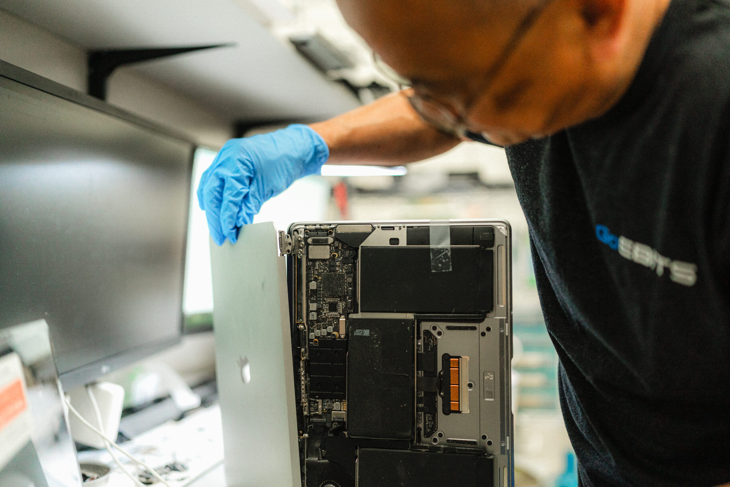 certified apple technician working on an apple macbook repair for battery screen and data recovery in seattle