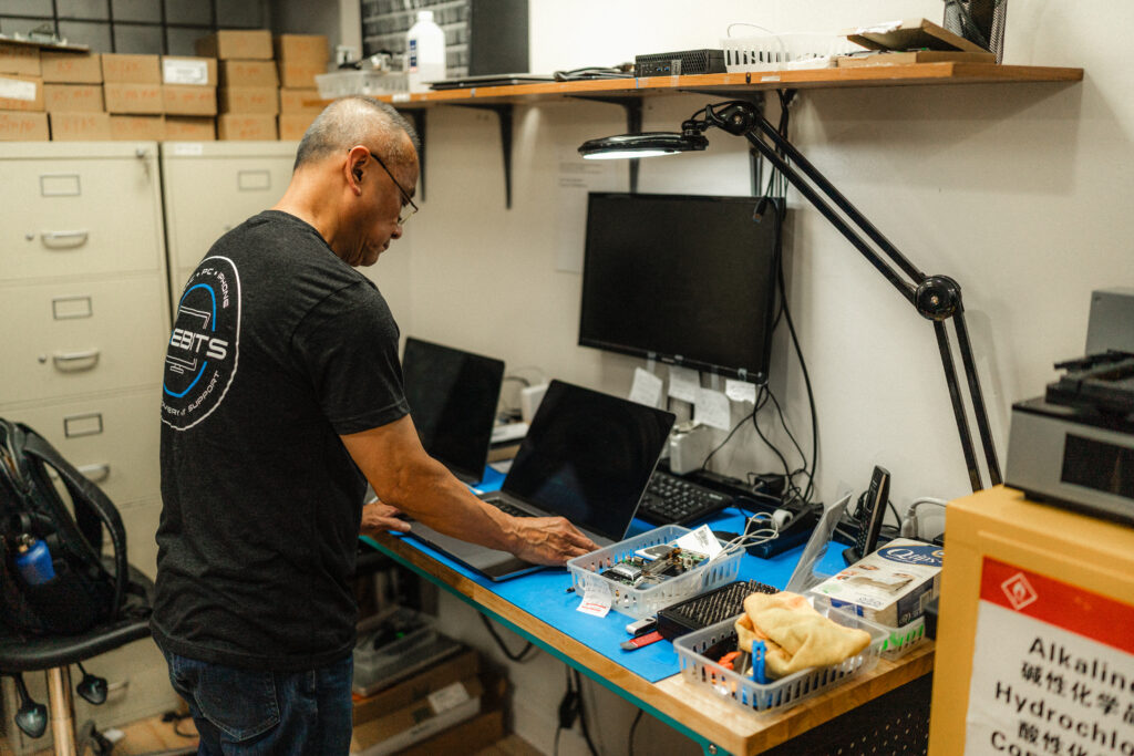certified apple technician repairing an apple macbook from water damage and recovering data off hard drive