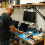 certified apple technician repairing an apple macbook from water damage and recovering data off hard drive