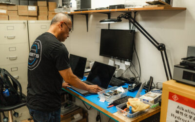 certified apple technician repairing an apple macbook from water damage and recovering data off hard drive