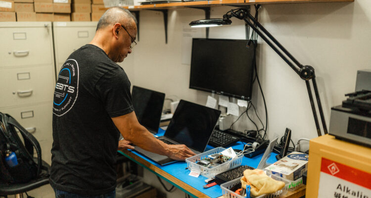 certified apple technician repairing an apple macbook from water damage and recovering data off hard drive